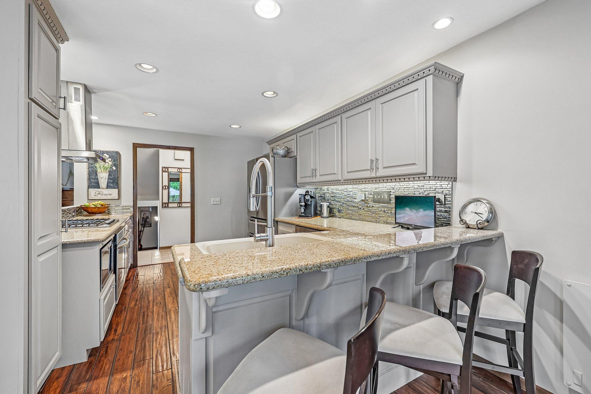 Back to the kitchen! Granite counters, stainless steel appliances, and cabinet lighting