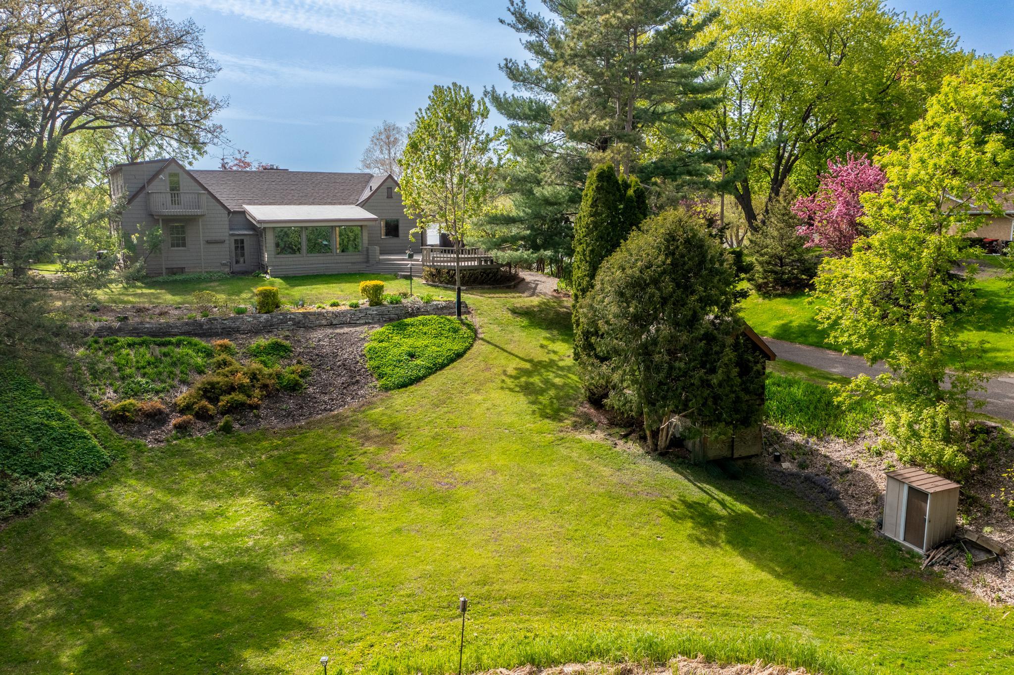 Expansive backyard with storage shed and more.