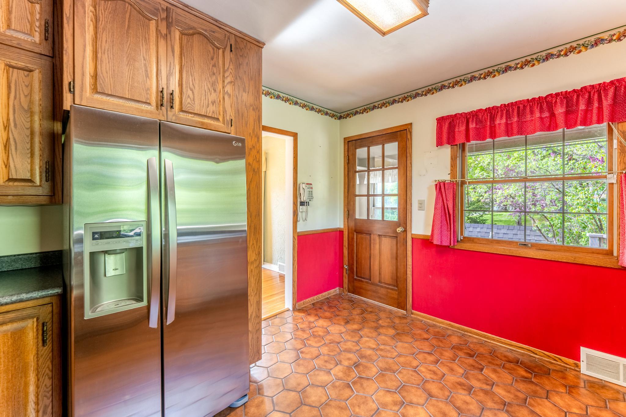 The door in this photo leads to a small, functional mudroom off the deck that serves as an organized drop zone for shoes and coats before entering the kitchen.