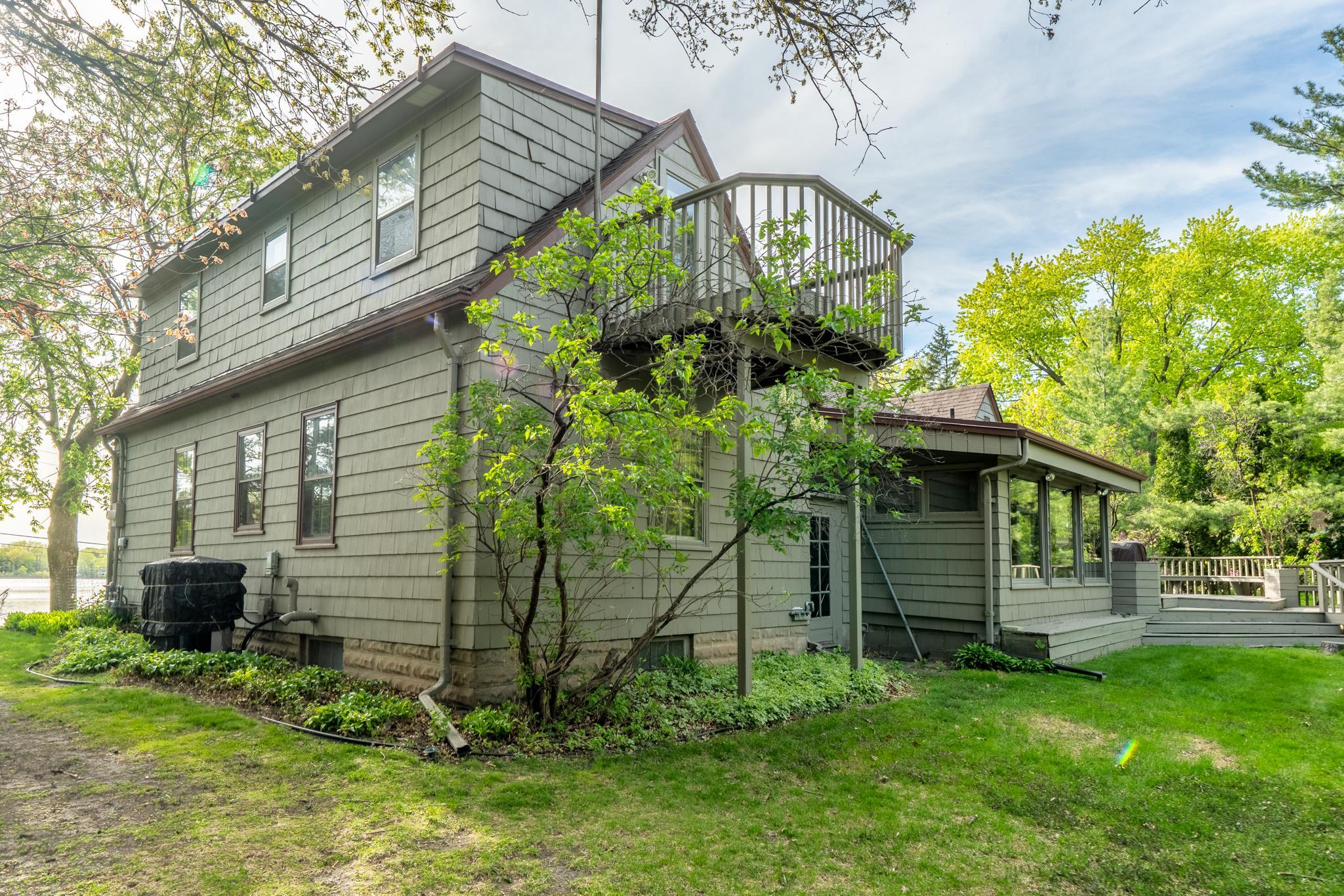Exterior view of balcony, sunroom and deck.