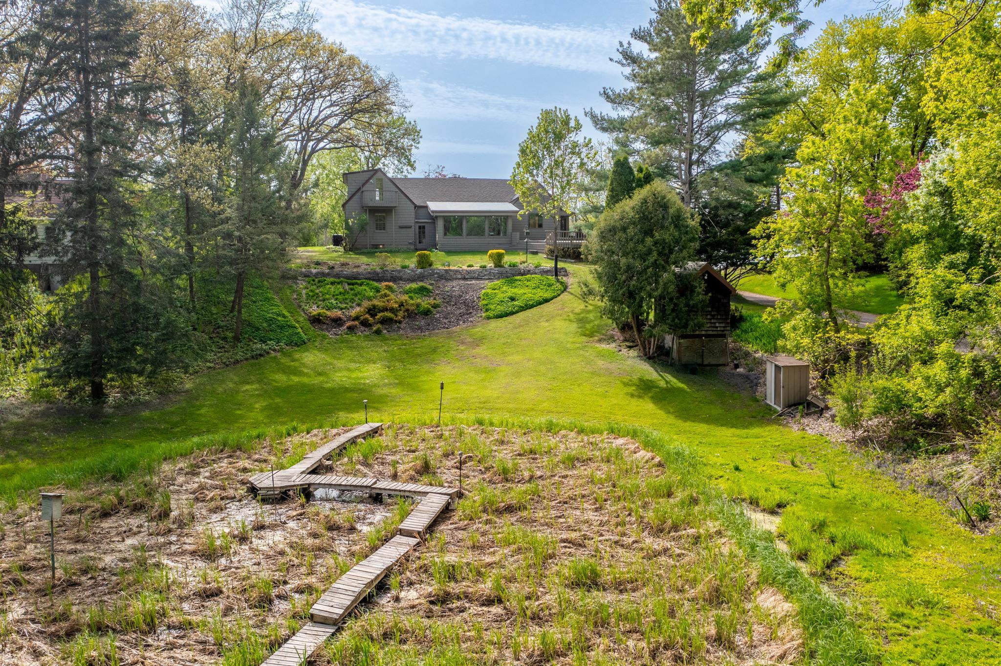 A natural wetland area, complete with a rustic wooden boardwalk.