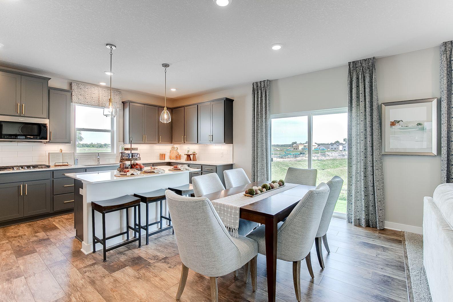 Well thought out, your main level has room for a coffee bar, informal dining and a large living area. Photo of model home, colors and finishes are similar.