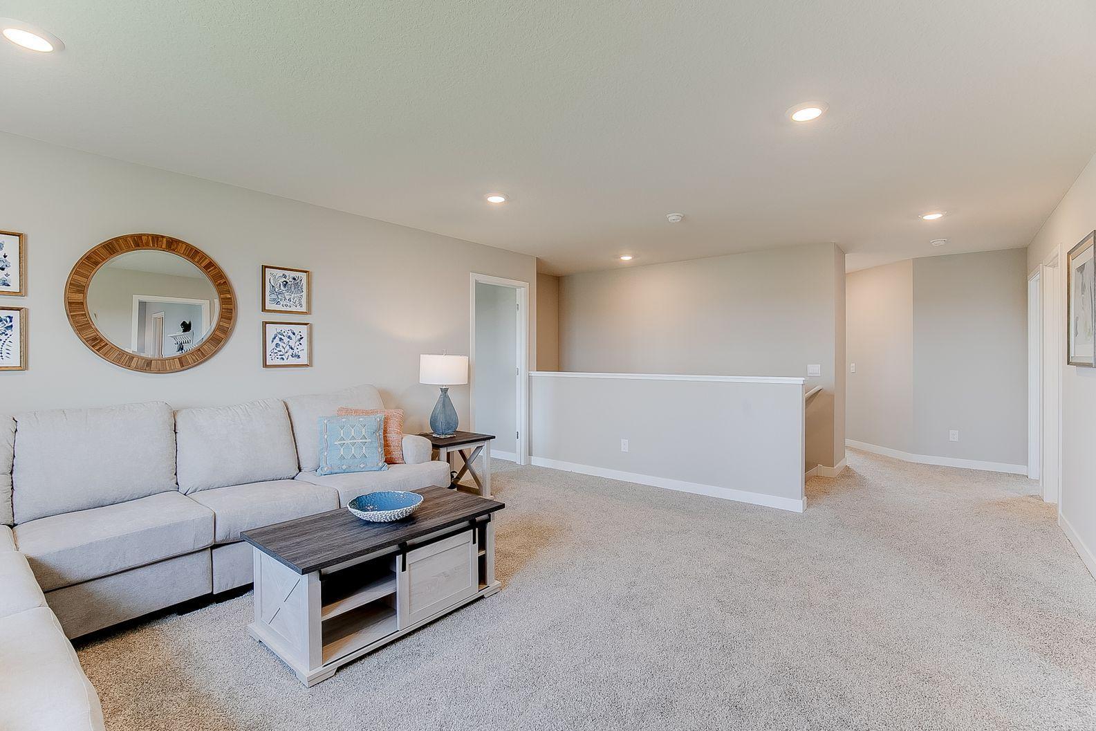 With room for large furniture or a sectional, there's space for everyone to relax. Photo of model home, colors and finishes are similar.
