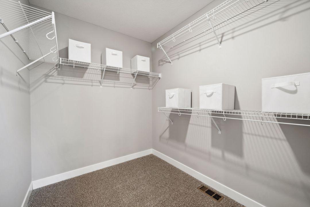 The second walk-in closet in the primary bedroom. Photo of model home, colors and finishes are similar.