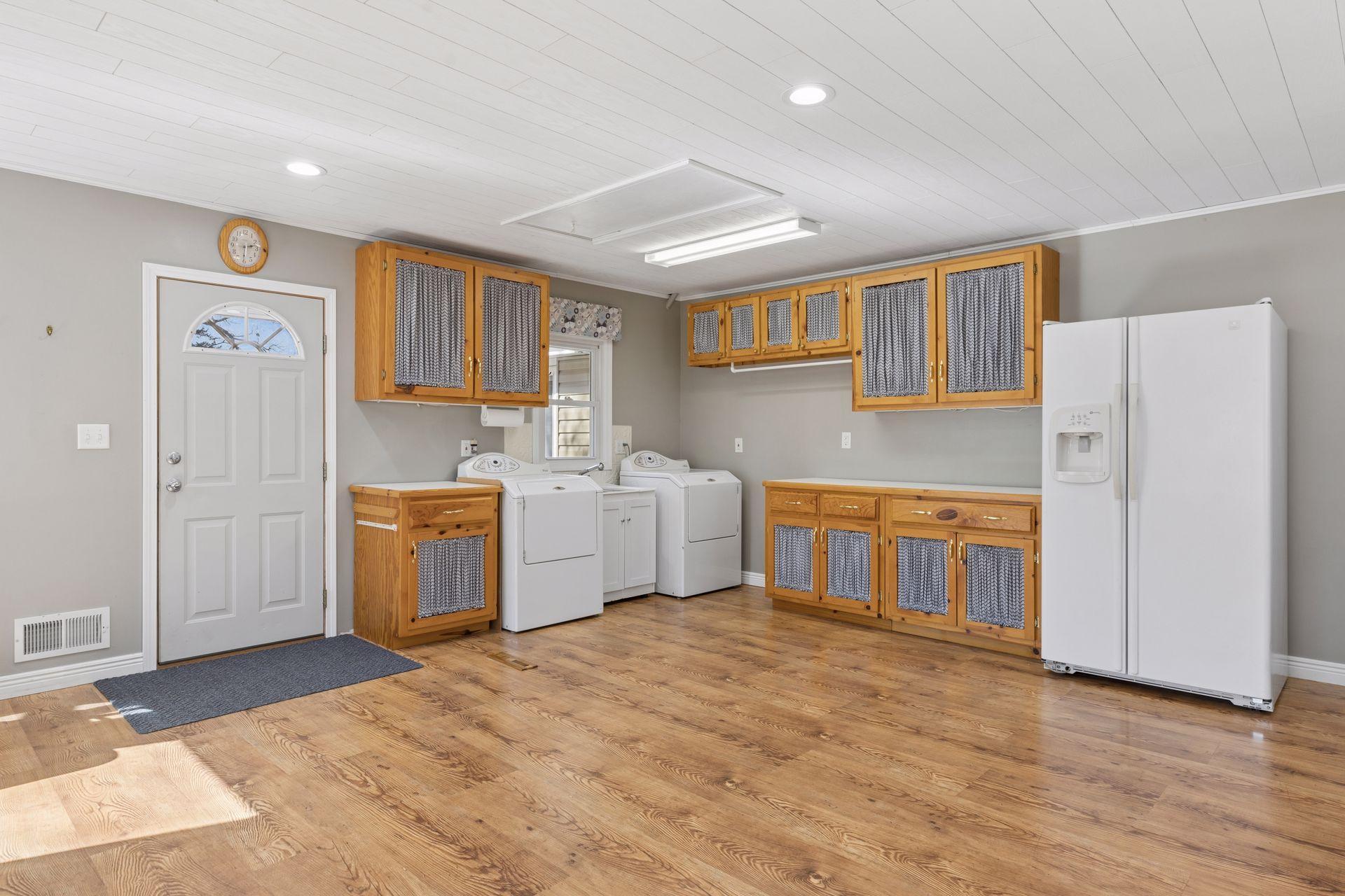 Currently, the laundry is here on the main floor. You could also move to the lower level. There is also access to the backyard and back driveway here.