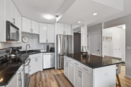 The inviting kitchen features granite counter tops, stainless steel appliances, and tons of counter / cabinet space!