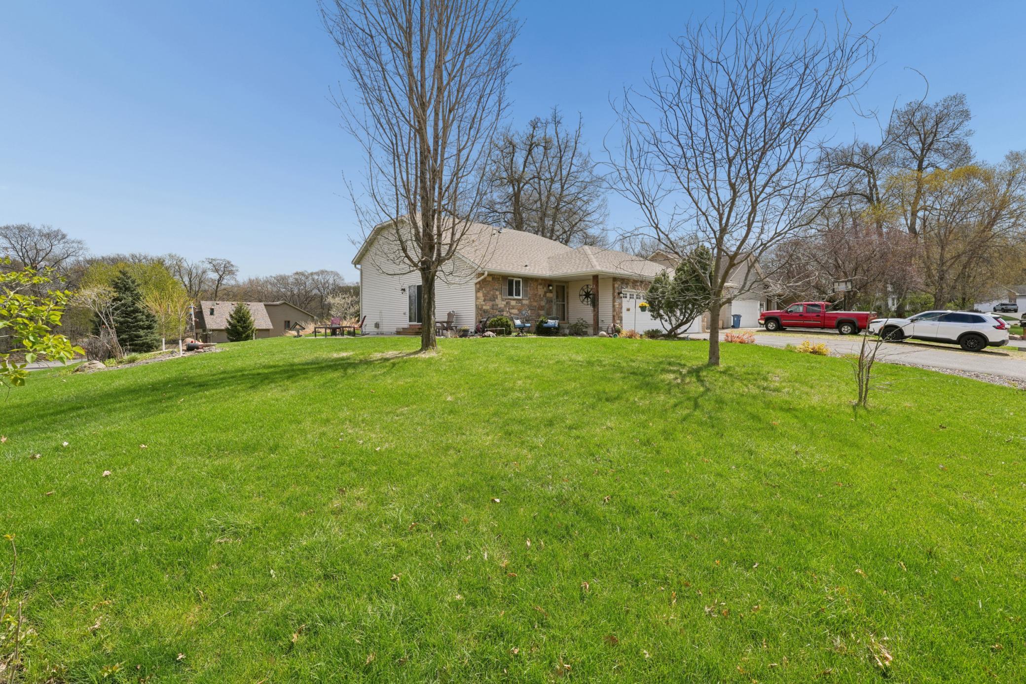 Spacious corner lot with several trees.