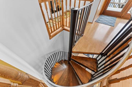 Well designed spiral stairway with stair lighting on the wall
