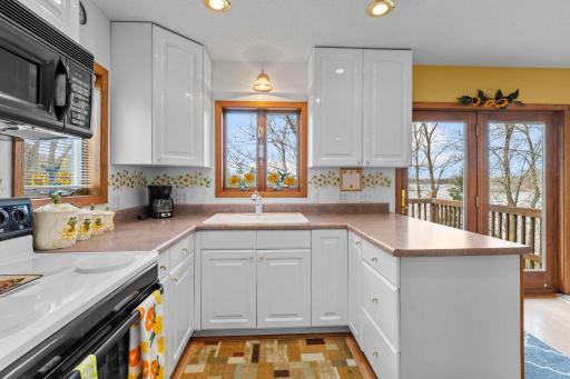 Plenty of cabinets in this bright & cheery kitchen