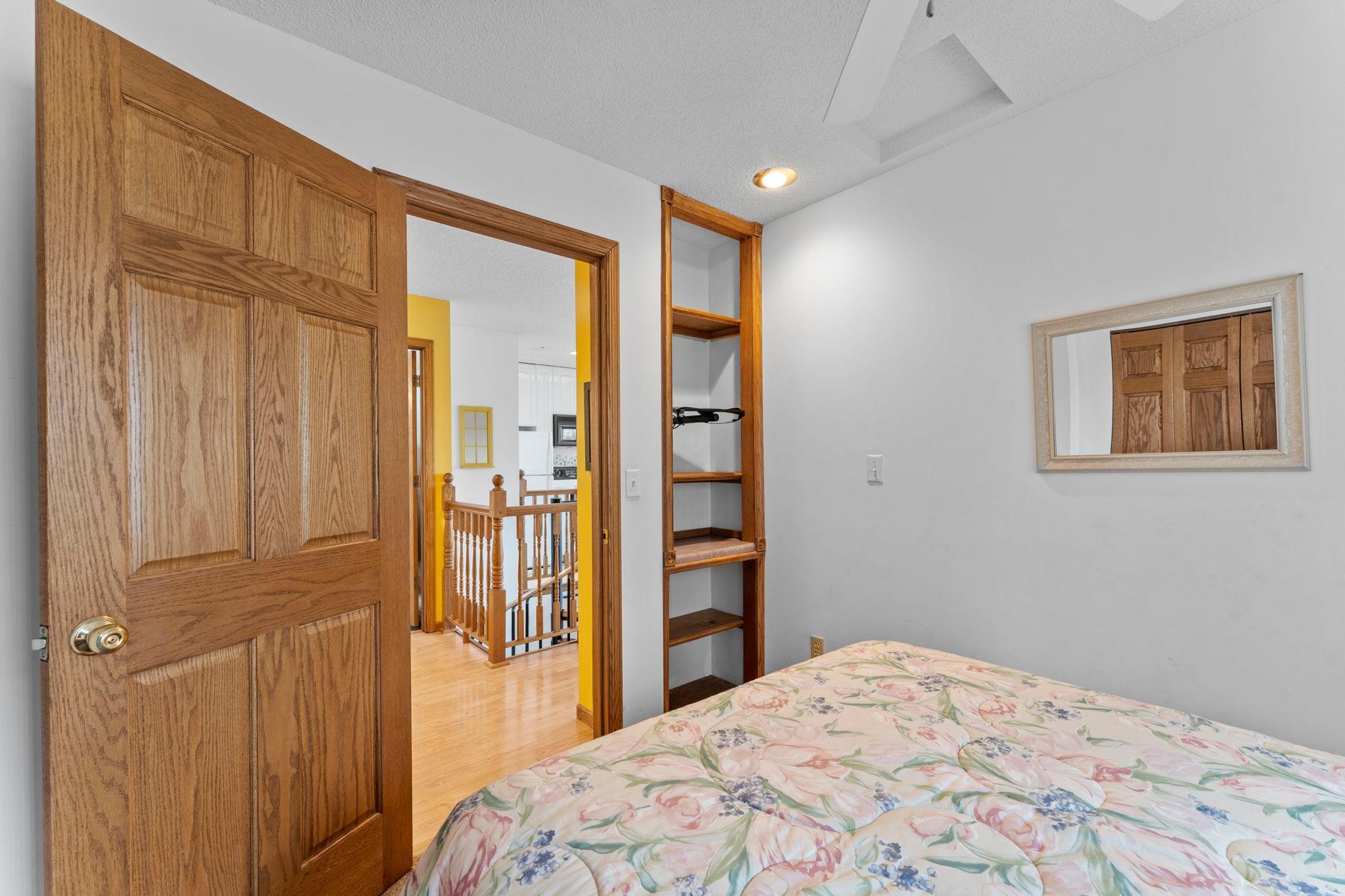 Corner bedroom built in shelving & tv mount