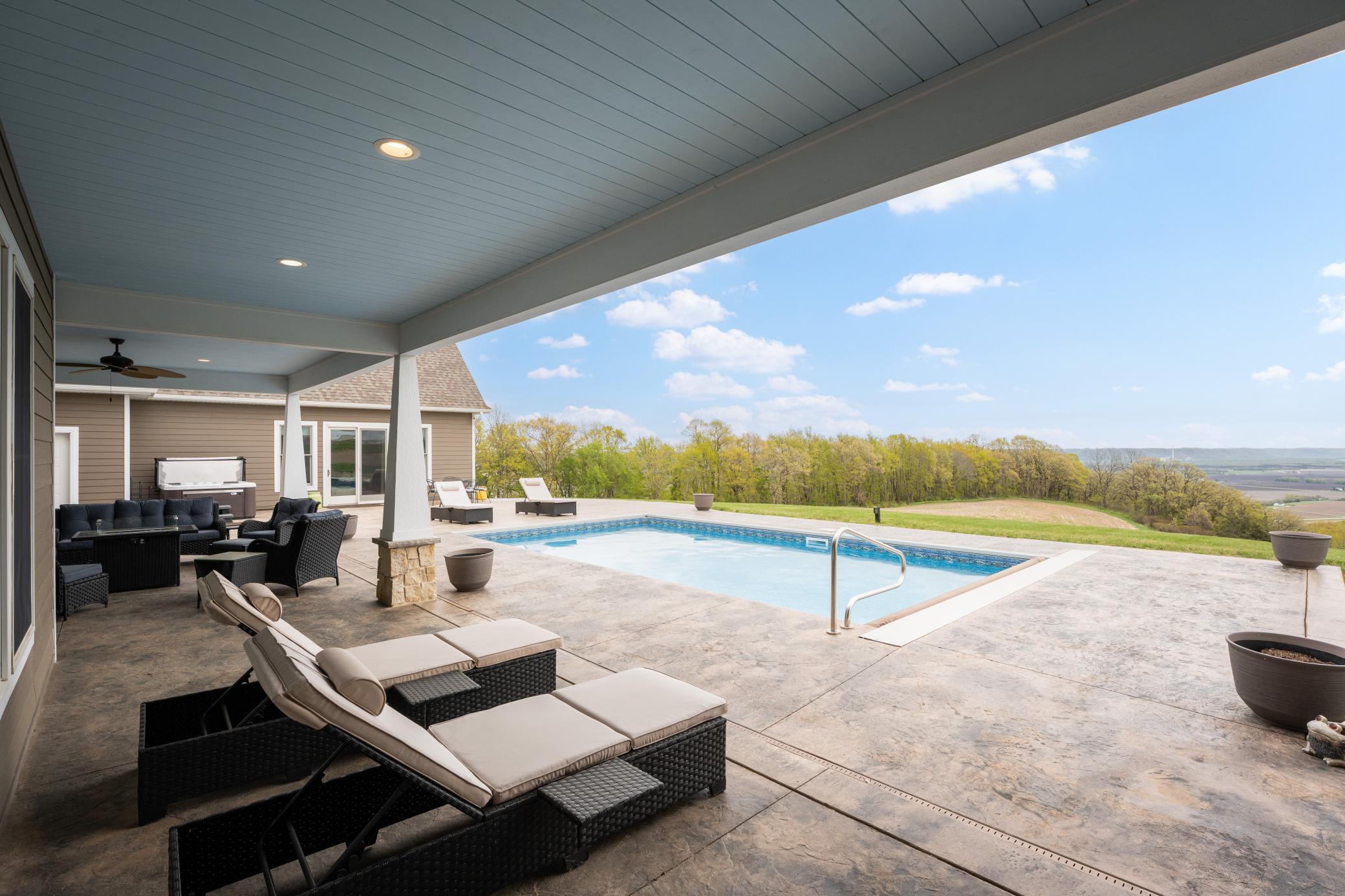 Multiple entertaining spaces, both covered and in the open on the stamped concrete patio