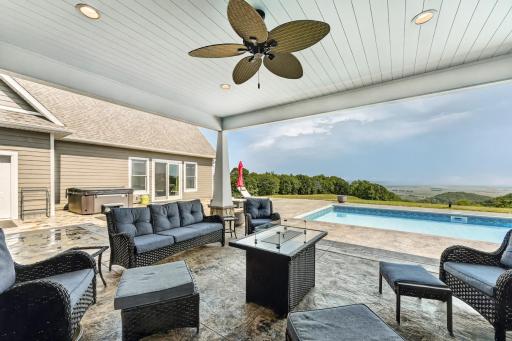 Multiple entertaining spaces, both covered and in the open on the stamped concrete patio