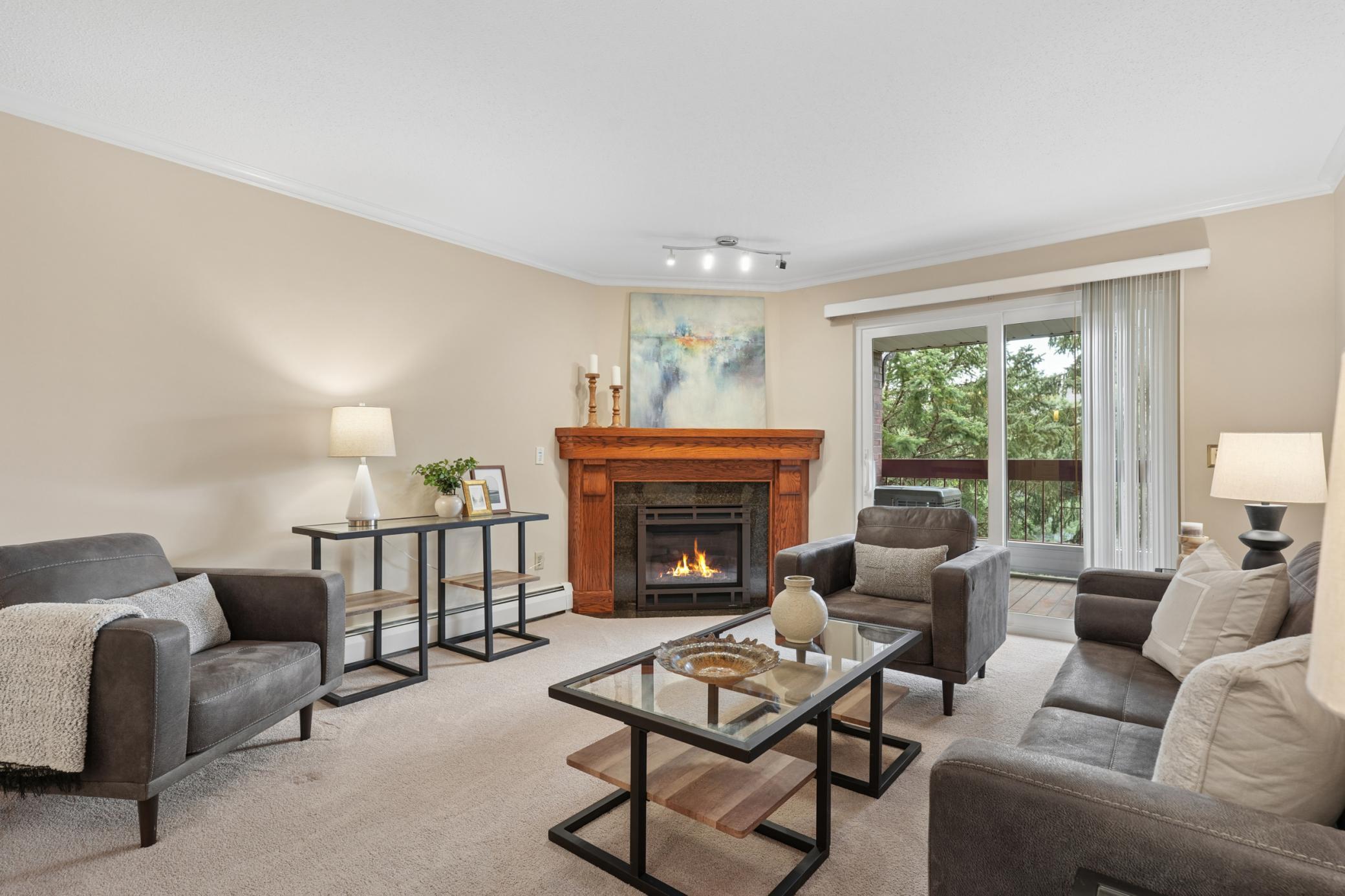 New fireplace and mantle & new sliding door to deck with a lovely south facing tree view!