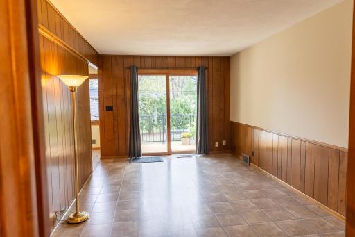 Den or Office right off the Kitchen features patio doors to deck