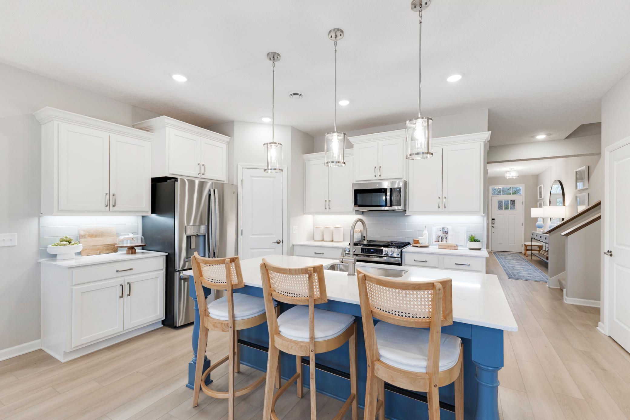 The kitchen is a wow- with an oversized island, corner pantry, gas range and loads of storage. Representational