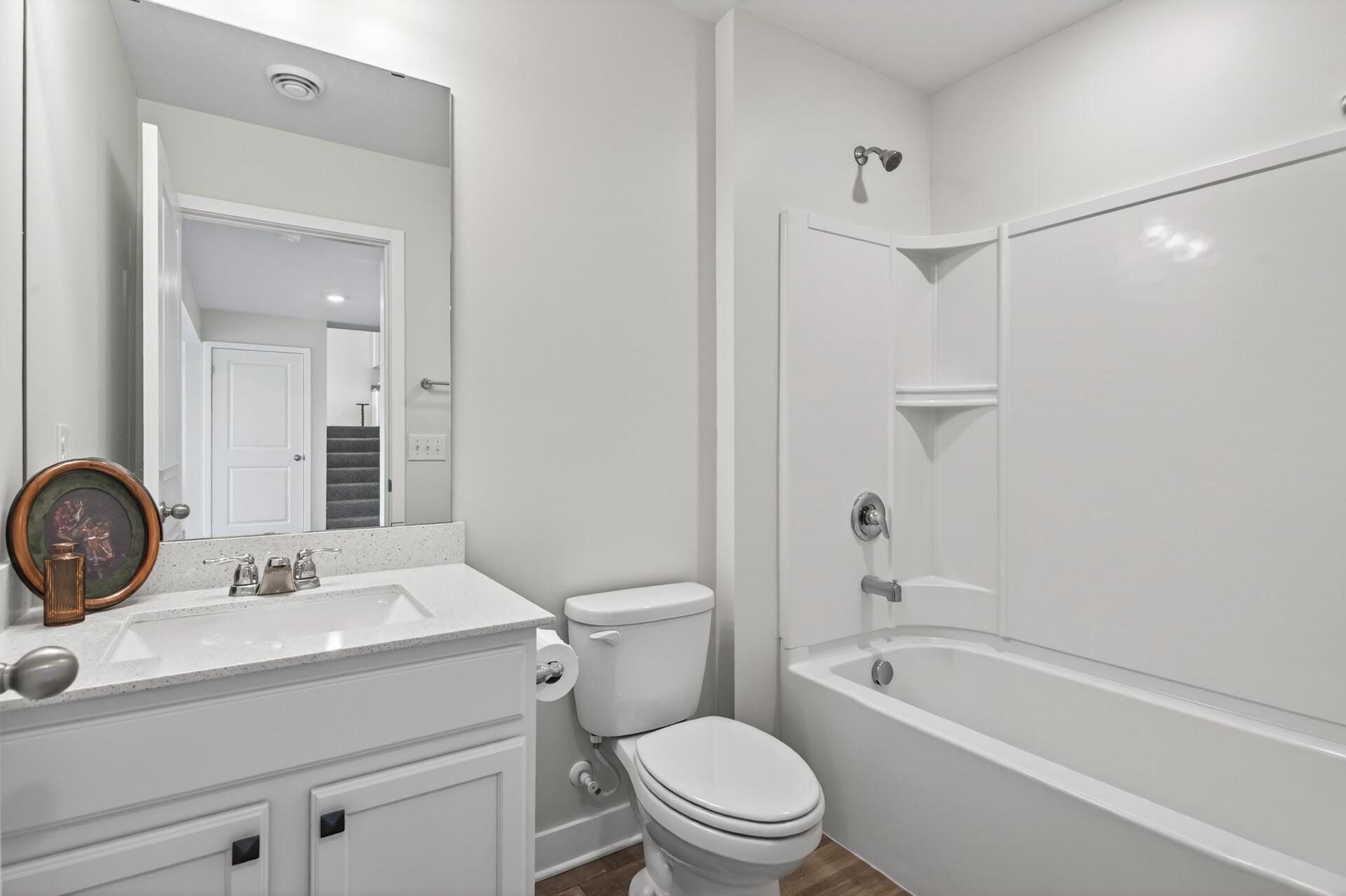 Additional full bathroom on lower floor designed with comfort and functionality in mind.