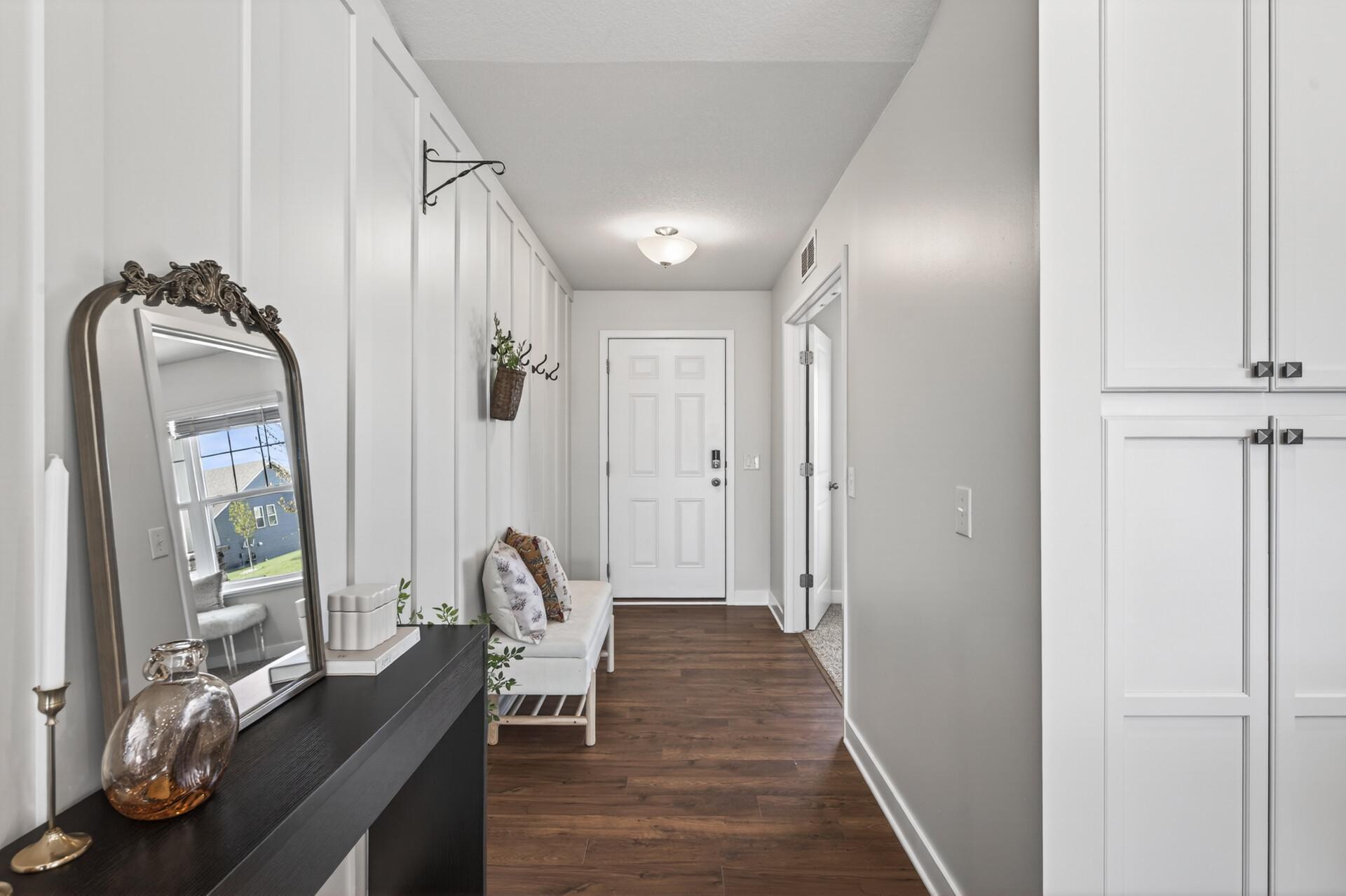 Welcoming entryway with warm wood flooring and a bright, modern feel.