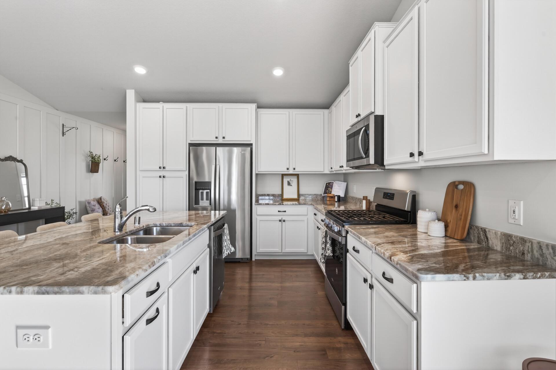 Bright kitchen featuring ample counter space and modern finishes throughout.