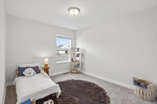 Bright secondary bedroom perfect for guests, family, or a home office.