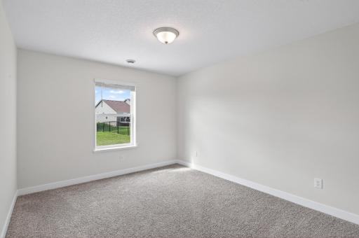 Bright lower-level bedroom with abundant natural light.