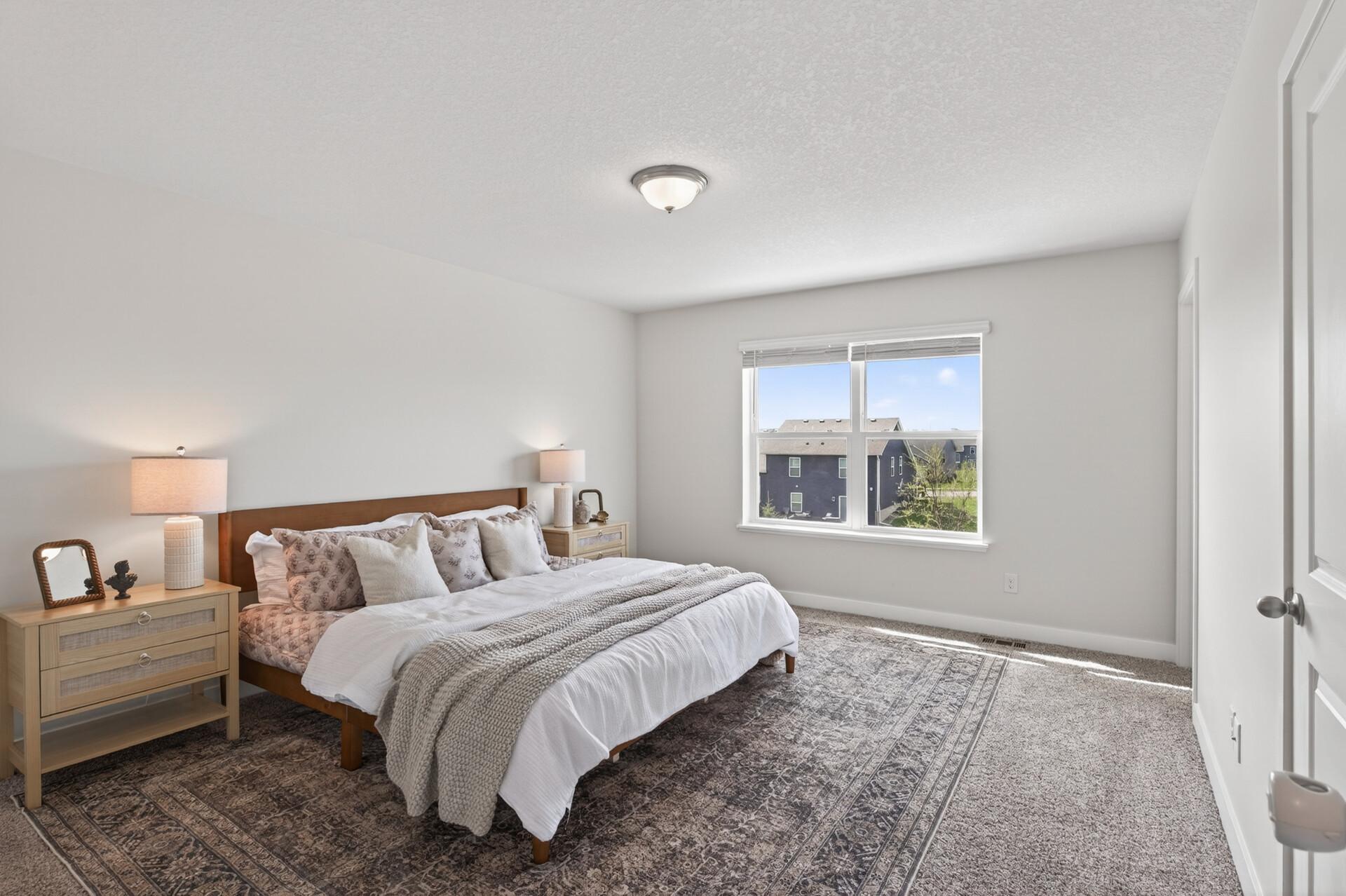 Spacious bedroom retreat with plush carpeting and plenty of natural light.