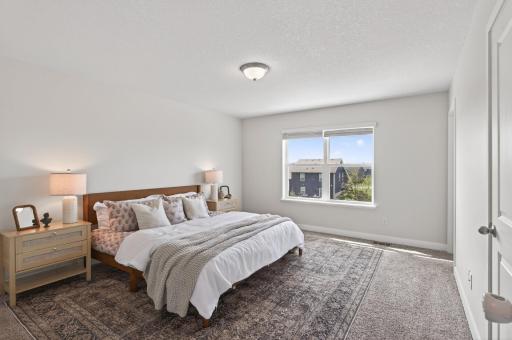 Spacious bedroom retreat with plush carpeting and plenty of natural light.