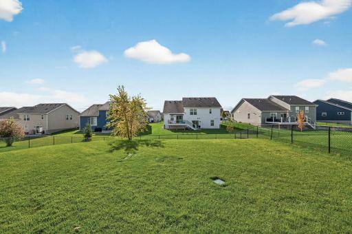 Fully fenced in backyard. Wide-open green space offering privacy and room to enjoy the outdoors..