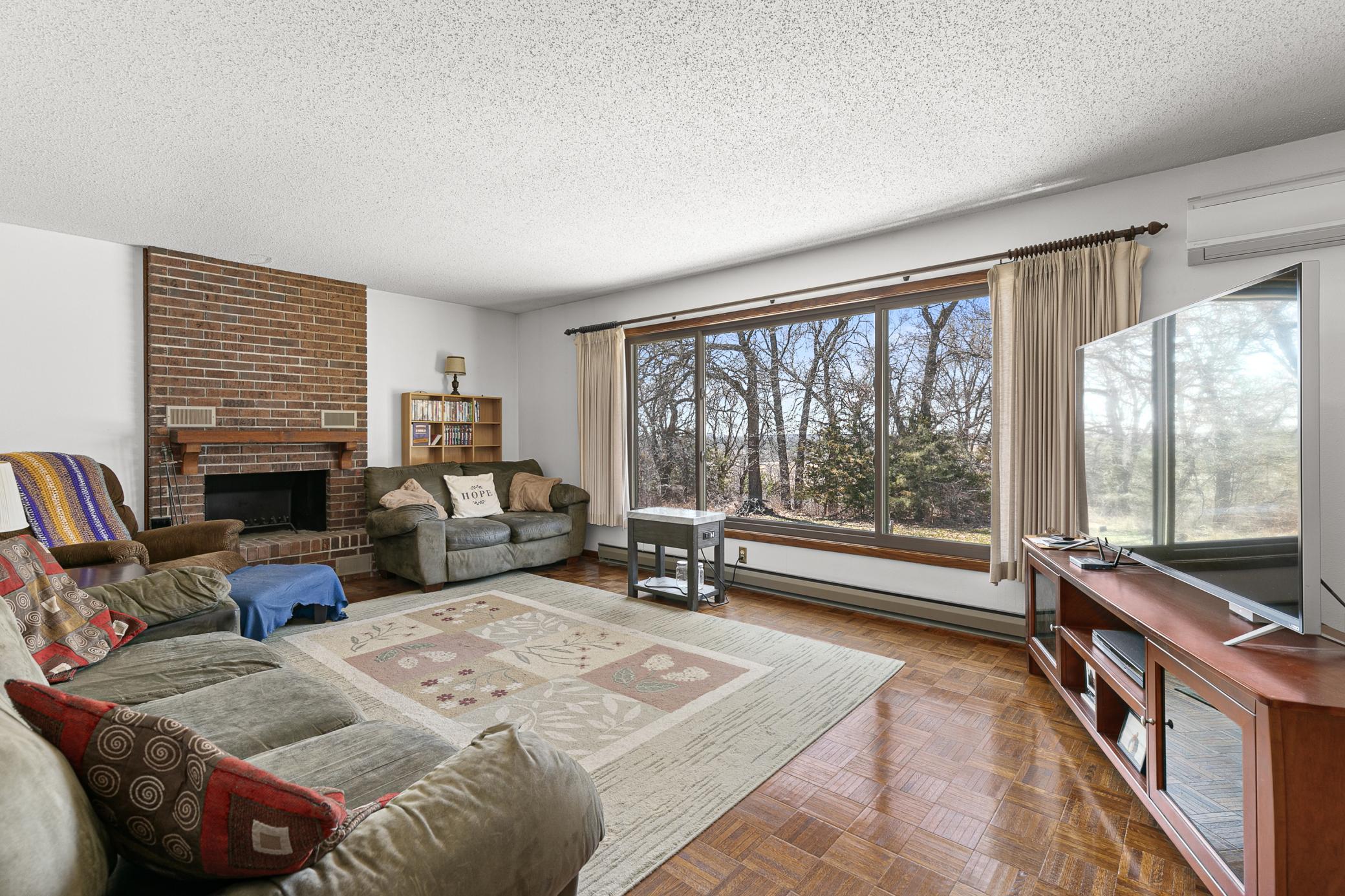 Main floor living room with brick fireplace and sunset view