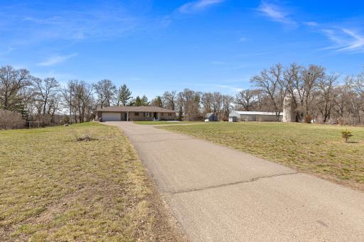 Paved driveway with a turn around spot or tarred to future shed site