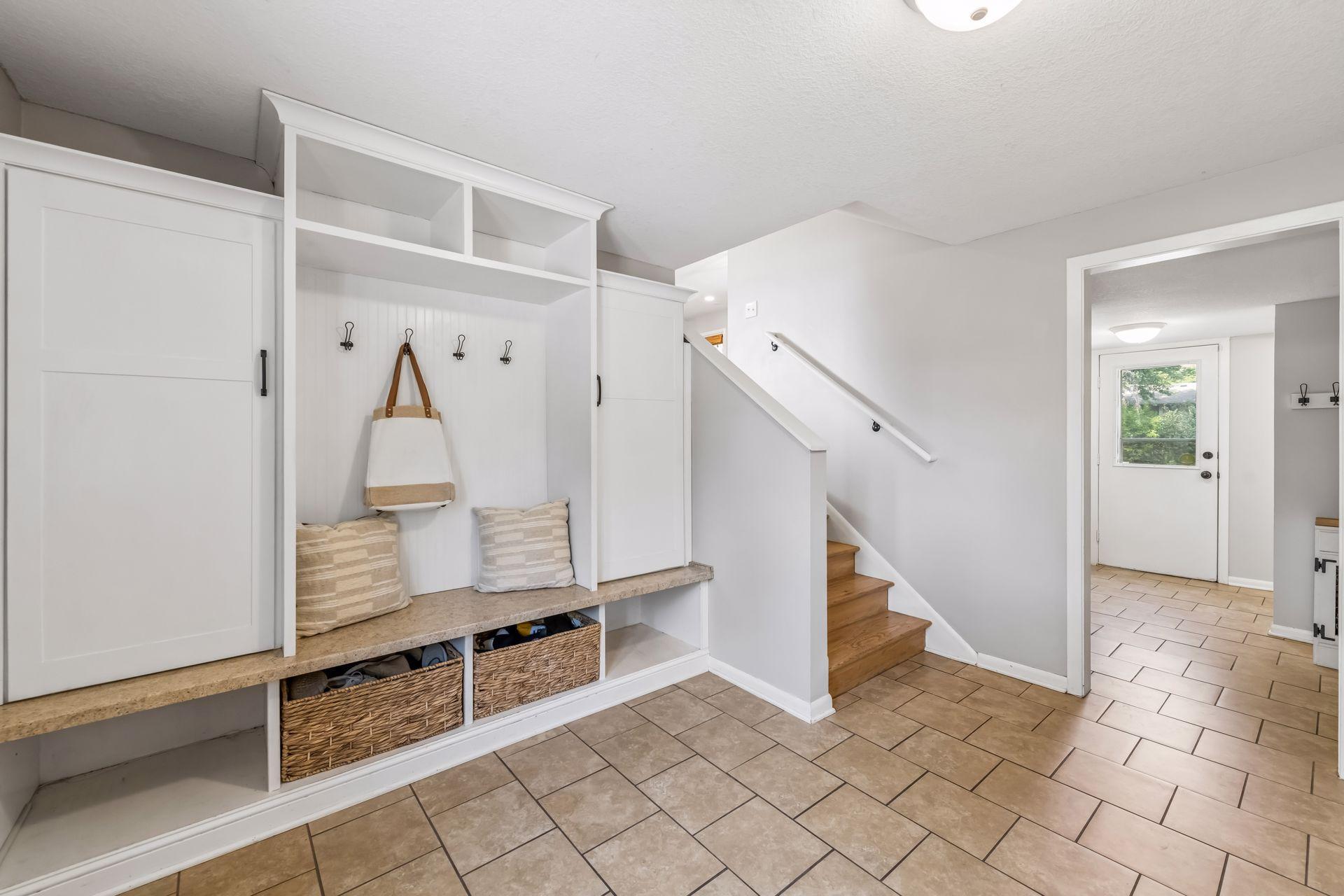 Wide mudroom with built in lockers and bench seating