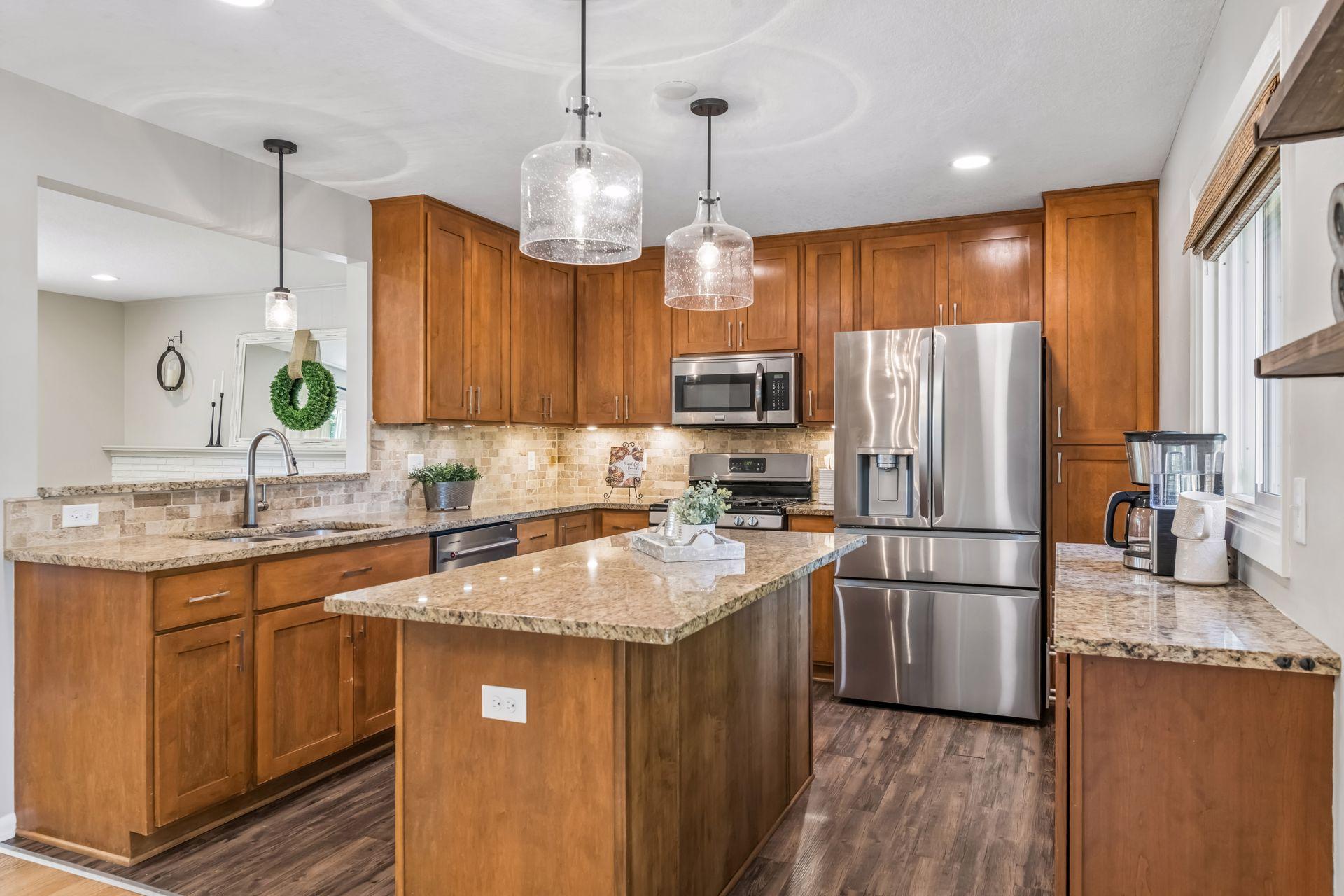Completely updated kitchen complete with stainless steel appliances, granite counters and pendant lighting