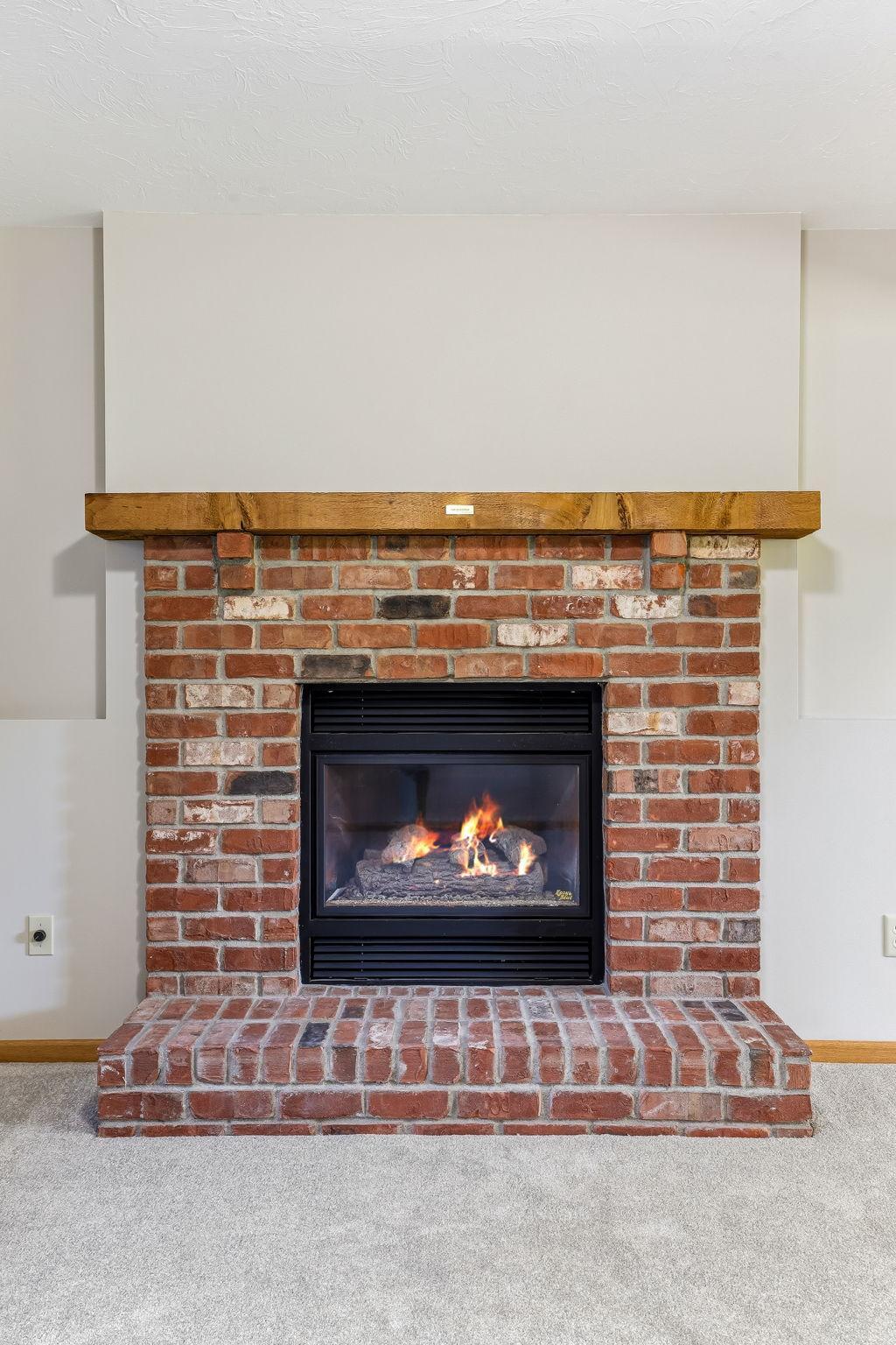 The gas fireplace brings effortless warmth and modern comfort to the family room.