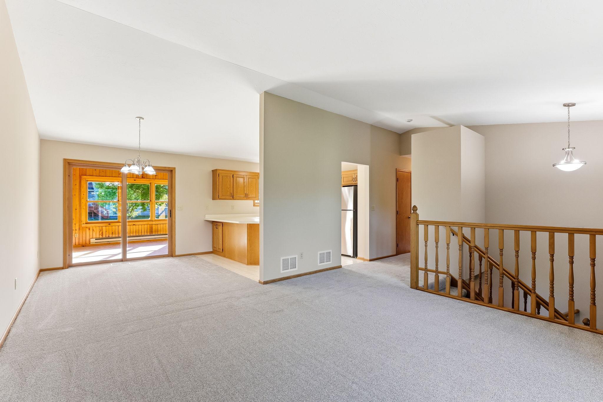 Beautiful open-concept living area featuring vaulted ceilings that enhance the sense of space and create an airy, inviting atmosphere.