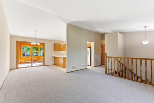 Beautiful open-concept living area featuring vaulted ceilings that enhance the sense of space and create an airy, inviting atmosphere.