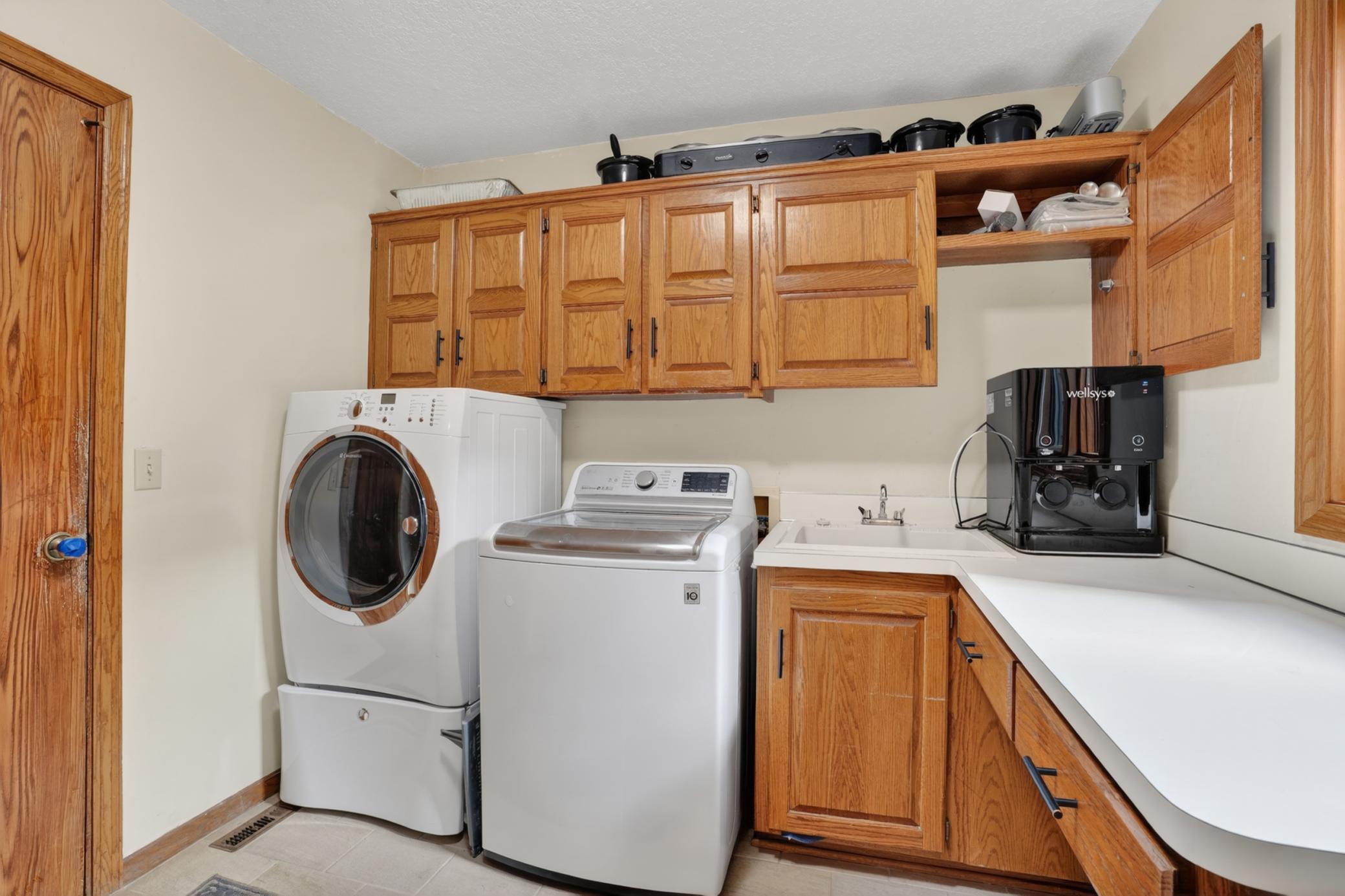 Laundry off garage with storage