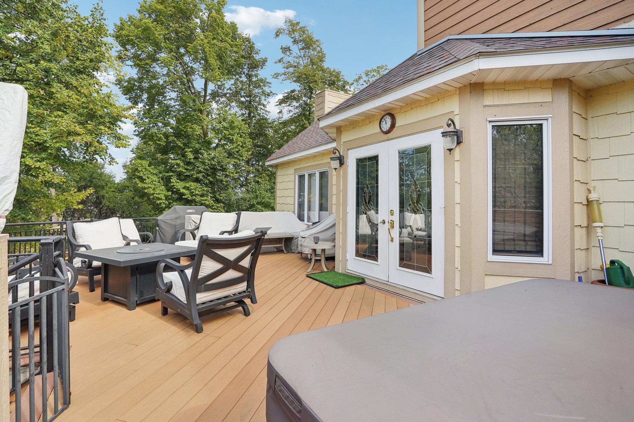 Enjoy time with family and friends outside on the expansive deck that includes a hottub.