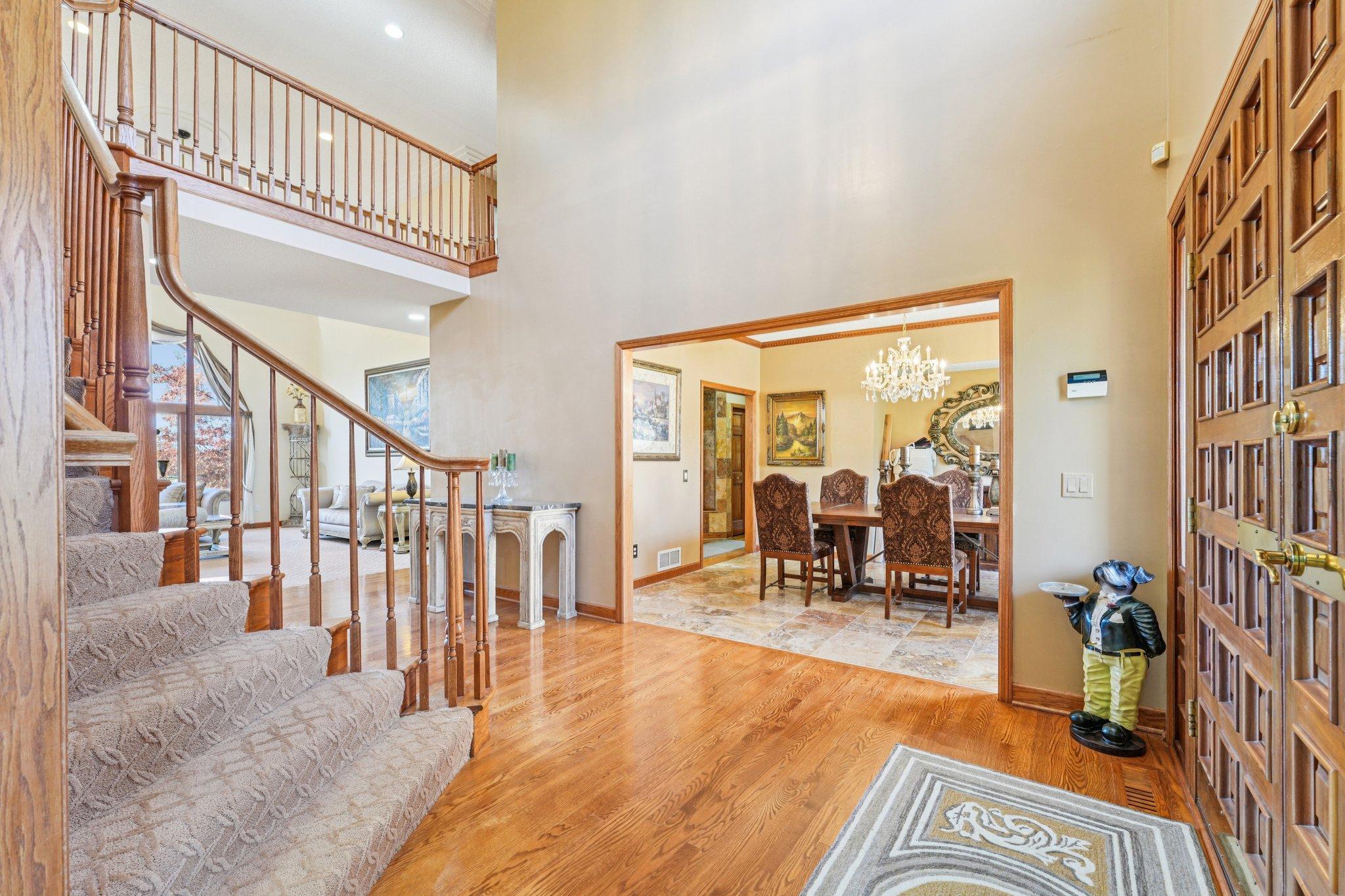 At the entry of the home you are greeted by a stately staircase and soaring ceilings.