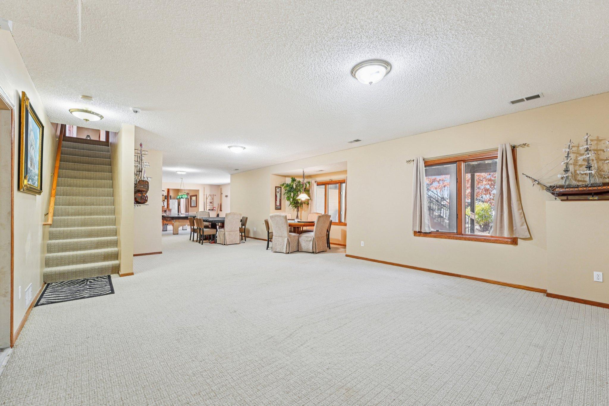 The expansive lower level features a walkout to the paver patio, bar, lots of living and entertaining space and tons of storage space.