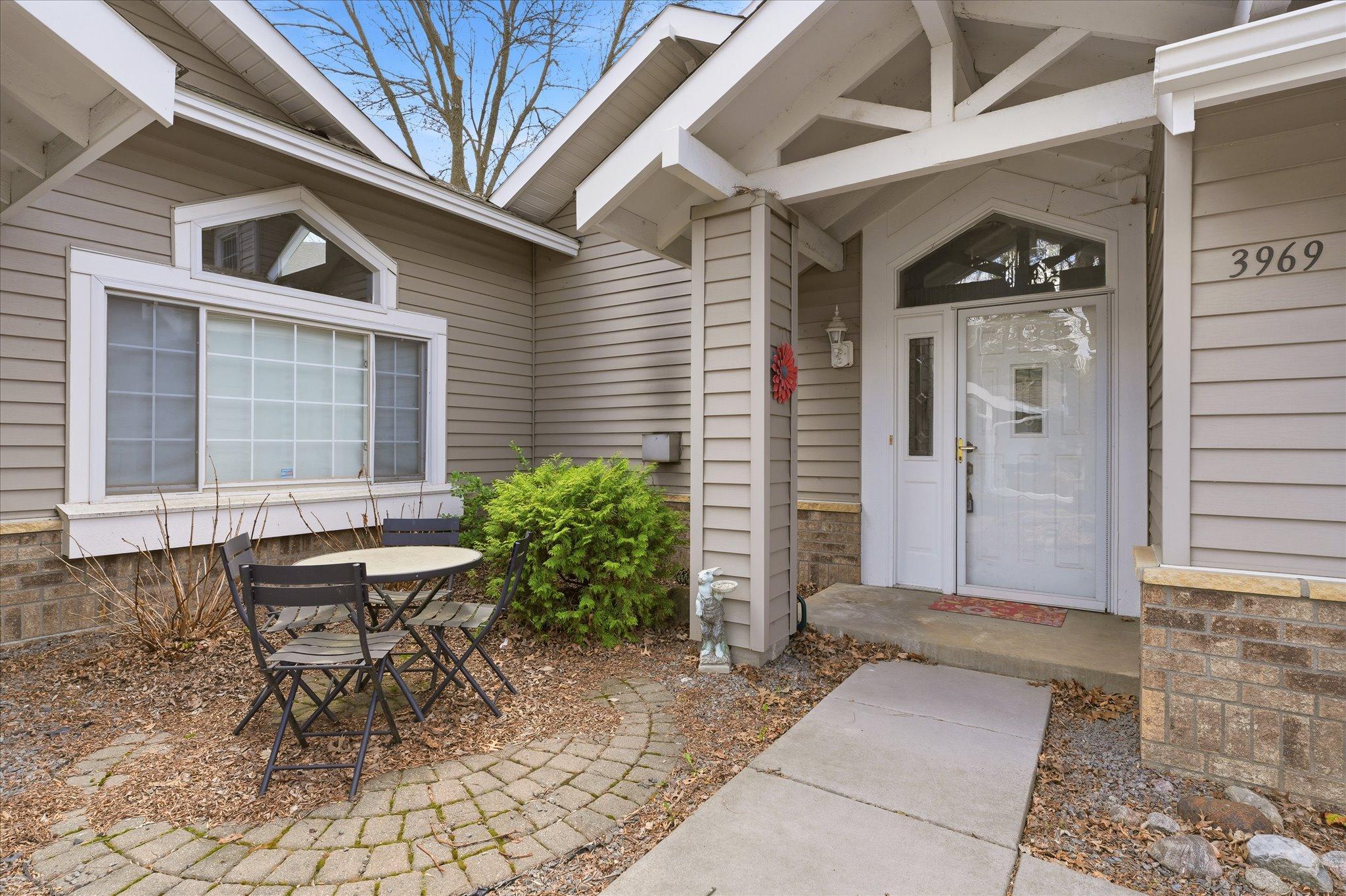 Welcoming front entry with a private patio area, perfect for morning coffee or relaxing outdoors.