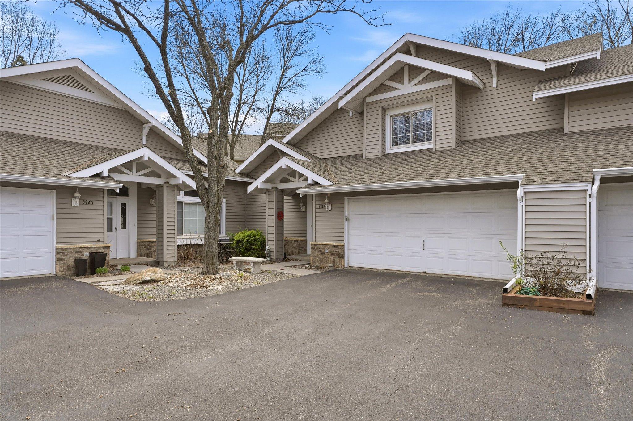 Well-maintained exterior with charming architectural details, neutral siding, and convenient attached garage with ample parking space.