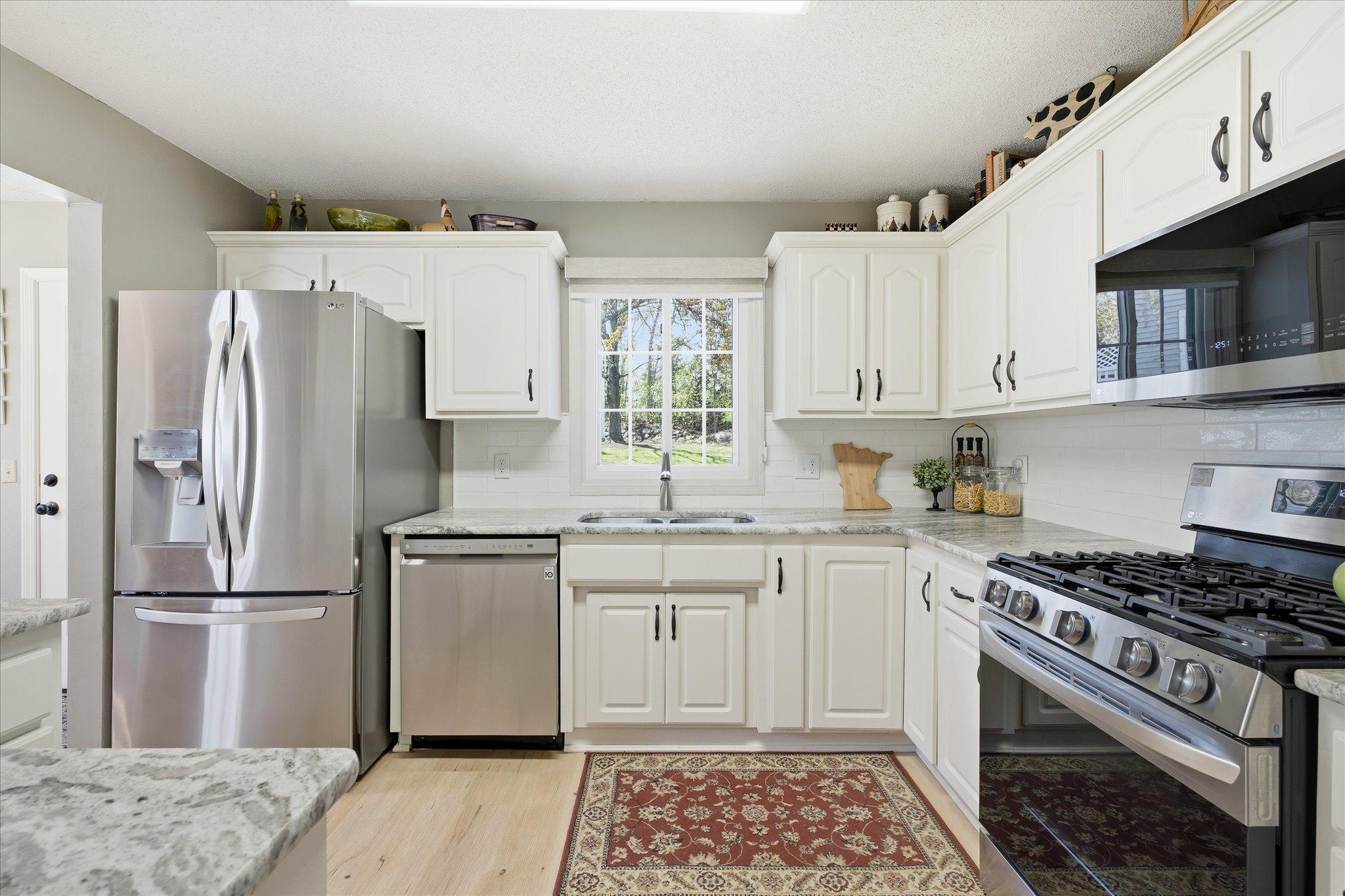 Well-appointed kitchen with an undermount sink, subway tile backsplash, and ample cabinet and counter space for everyday living.