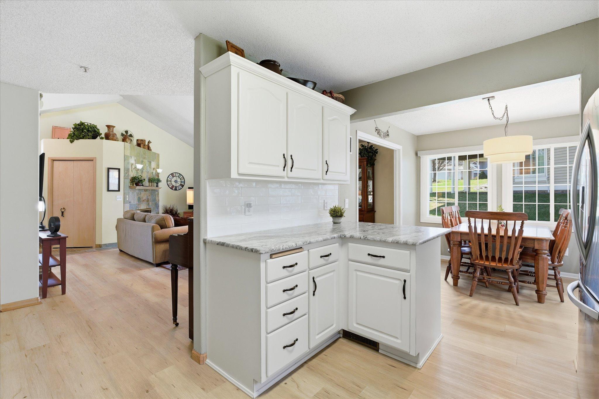 Open-concept kitchen with convenient layout, breakfast bar area, and seamless flow into dining and living spaces.