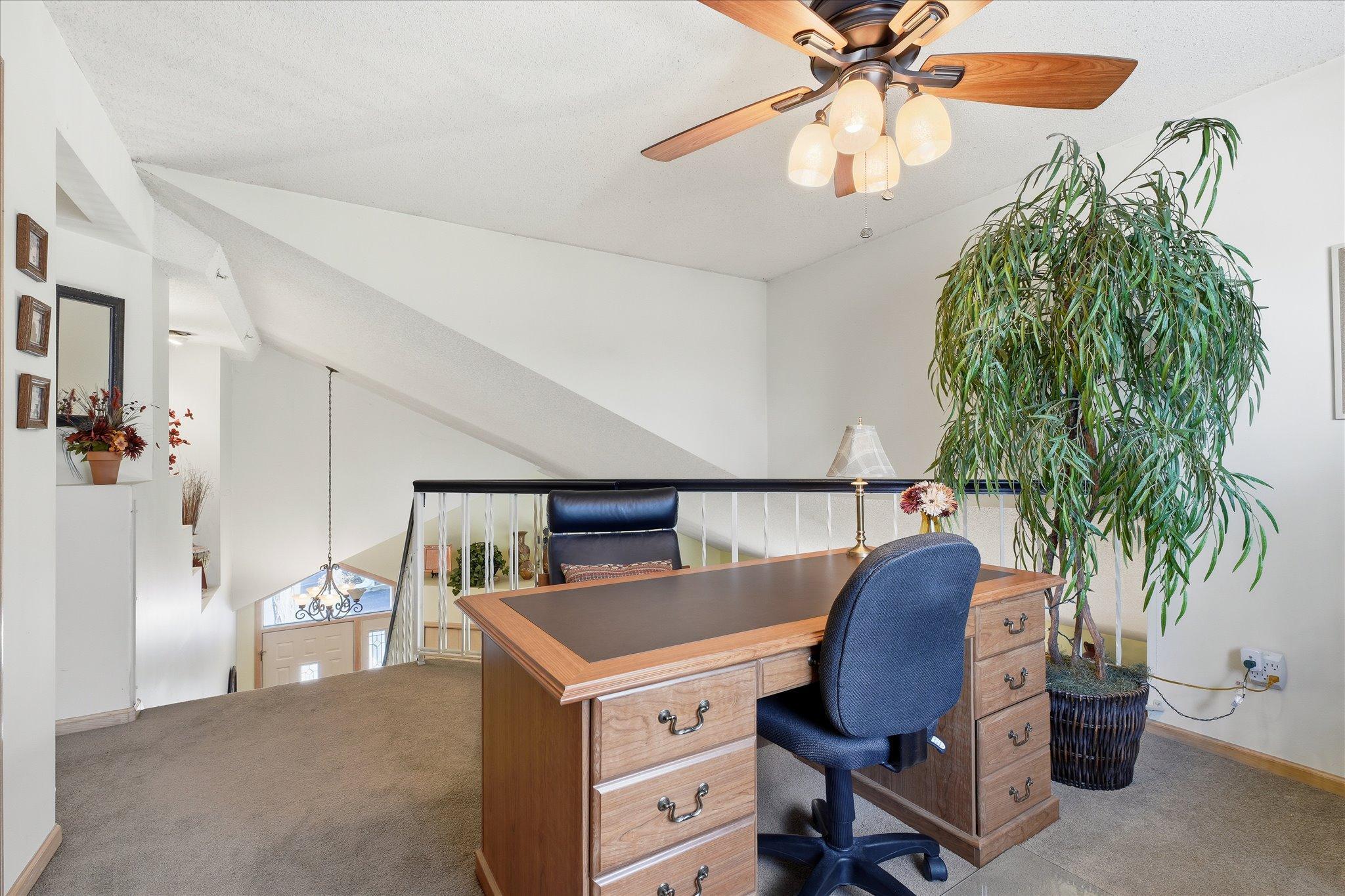 Open loft overlooking the main level, perfect setup for a home office or flex space.