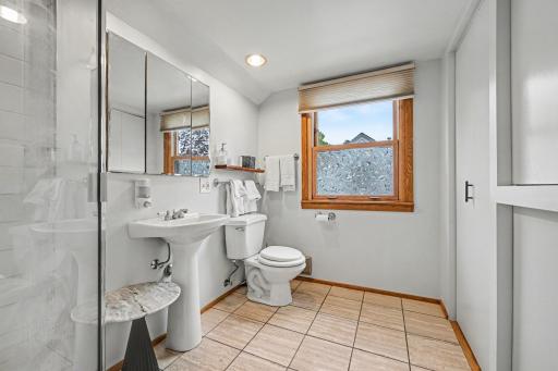 Bathroom - upper level with shower in foreground and nice natural stone/marble squares.