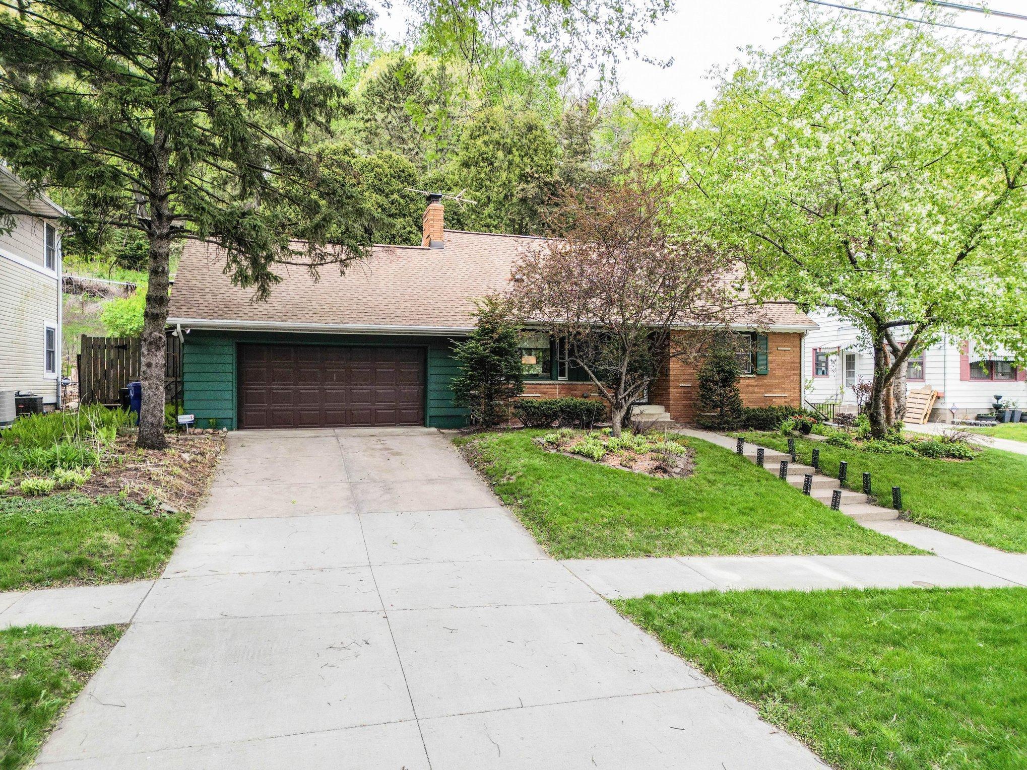 Front with two car attached garage and room to park cars in driveway !
