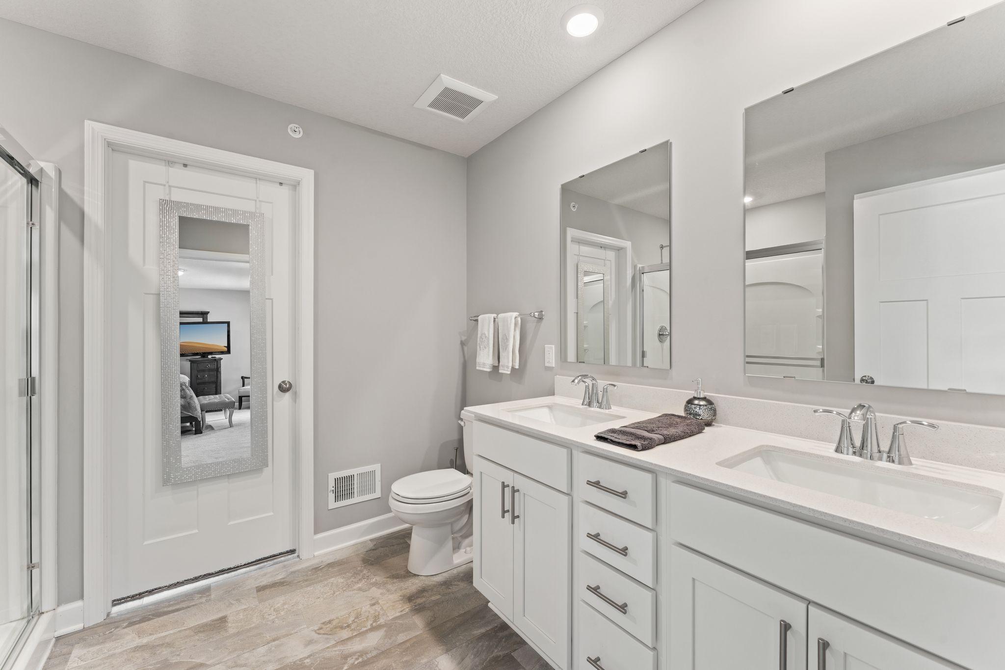 Primary Bathroom with Dual Sinks and Large Shower