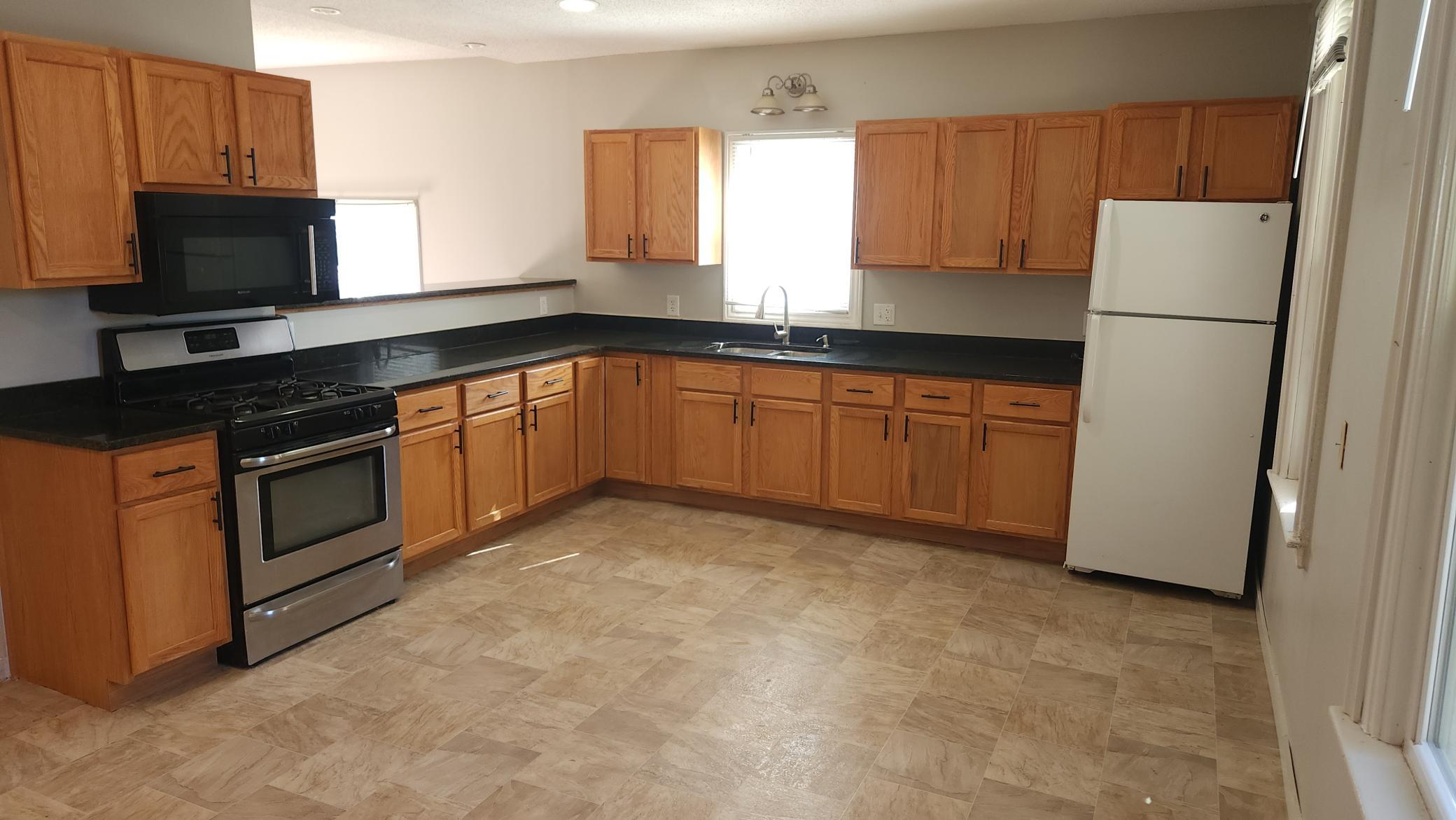 Unit #1 - Updated eat-in kitchen with granite countertops