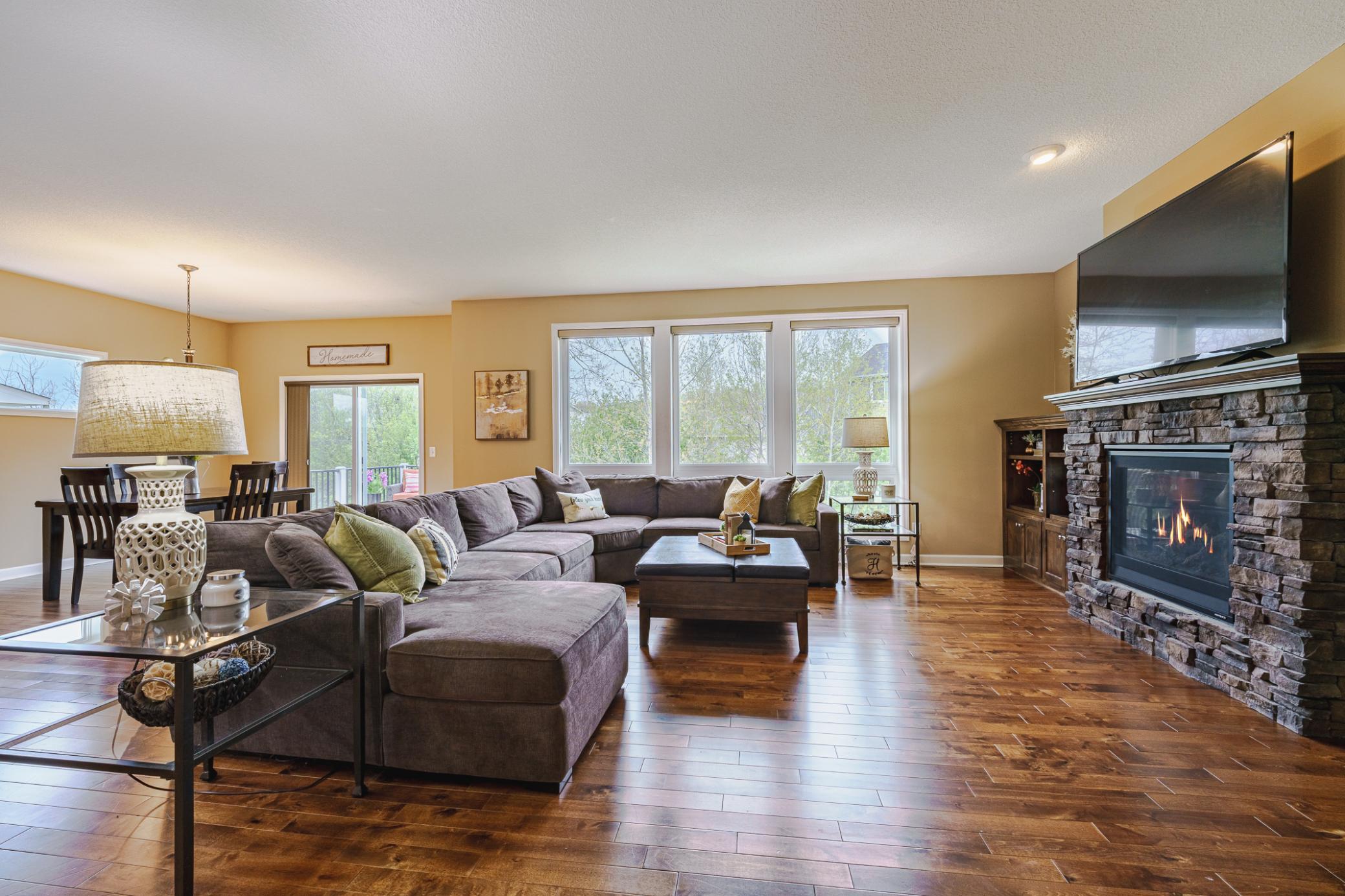 The main family room features 9-foot ceilings with recessed lighting and three large windows. Birch hardwood floors run throughout this room.