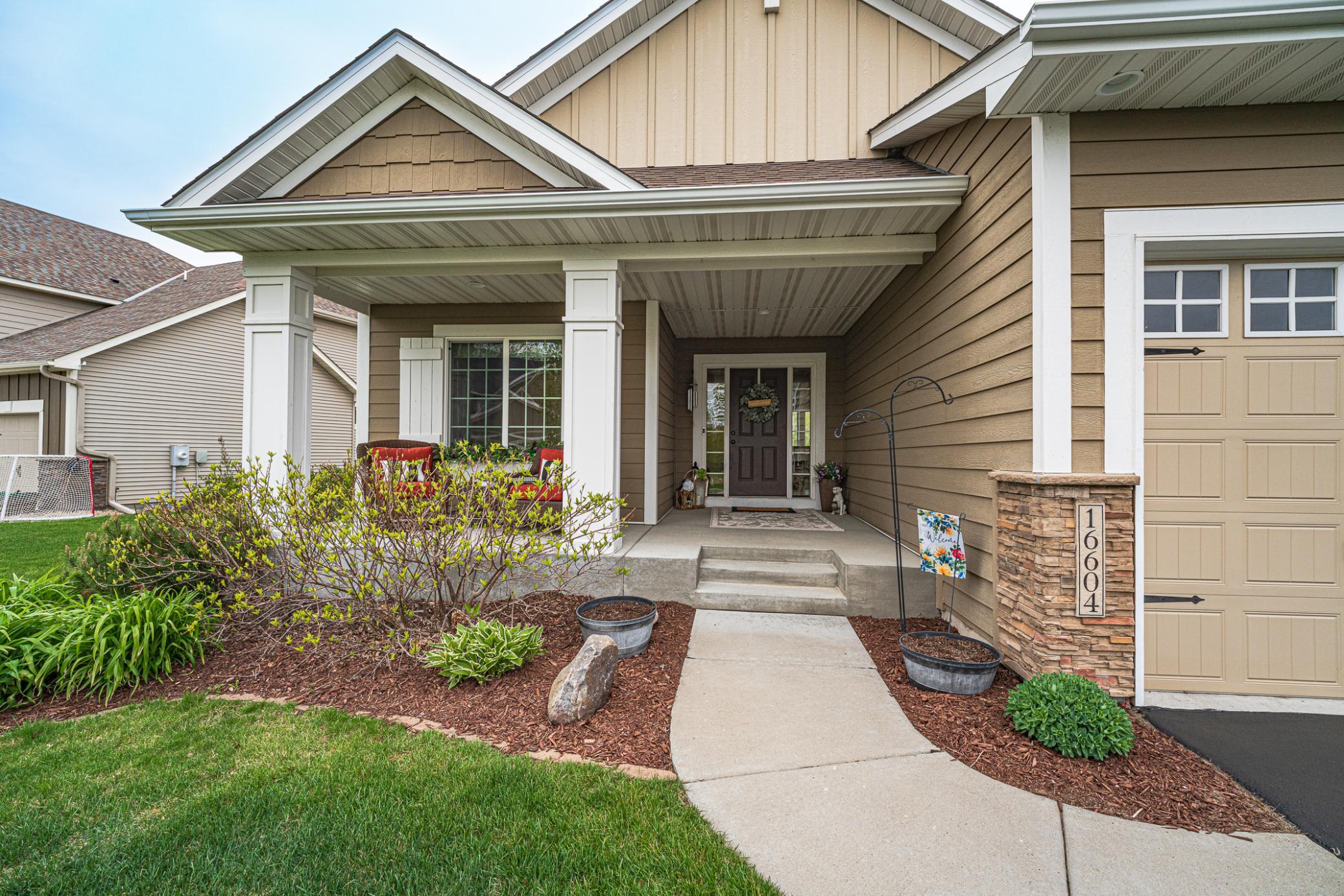 A charming concrete front porch greets you as you approach the home.
