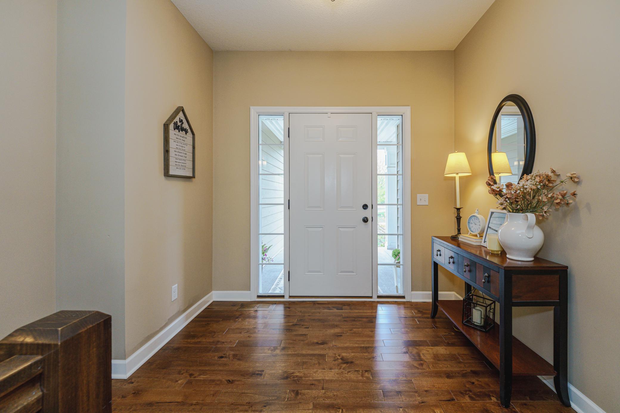 The entry foyer has birch hardwood flooring and two full-view sidelight windows flanking the front door. There is plenty of room for your favorite bench, table or credenza.